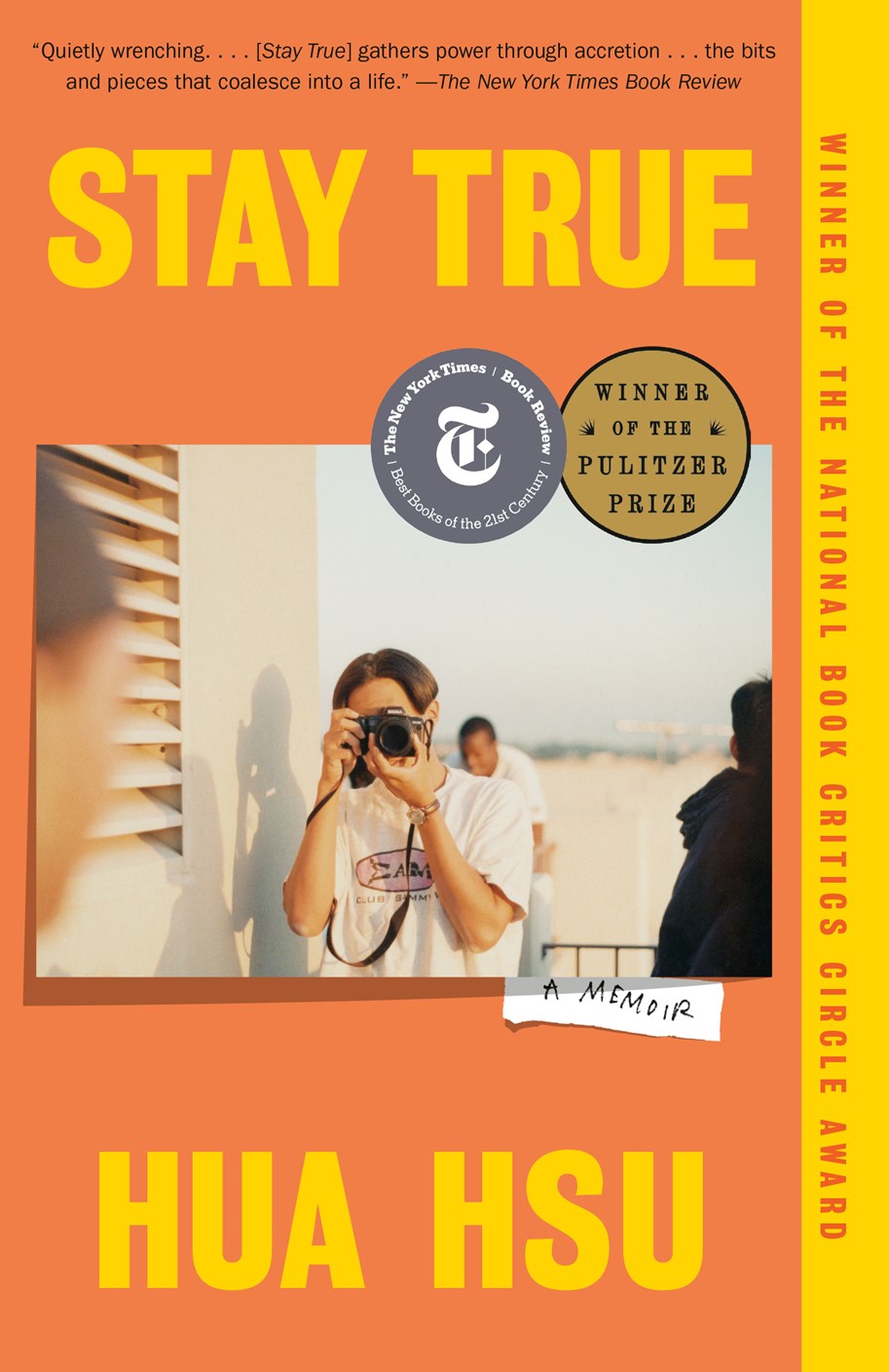 Signed copy of Stay True by Hua Hsu from Yu & Me Books. The orange cover shows a person taking a photo, with bold yellow and white text, award stickers, and praise for this Pulitzer Prize-winning memoir.