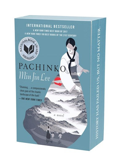 Book cover for Pachinko by Min Jin Lee (Signed!), a saga of a Korean immigrant family featuring a National Book Award finalist seal and an illustration of a woman overlooking a mountainous landscape.