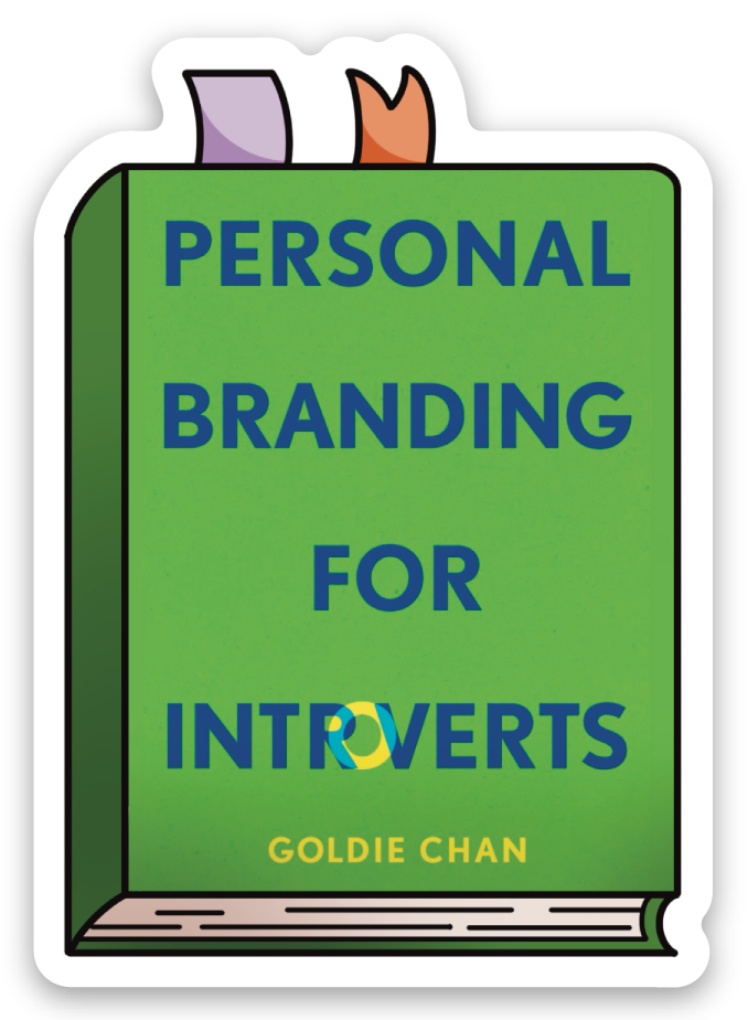 A signed and personalized green copy of Personal Branding for Introverts by Goldie Chan from Yu & Me Books includes two ribbon bookmarks, a sticker, and a keychain—ideal for introverts seeking expert branding advice.