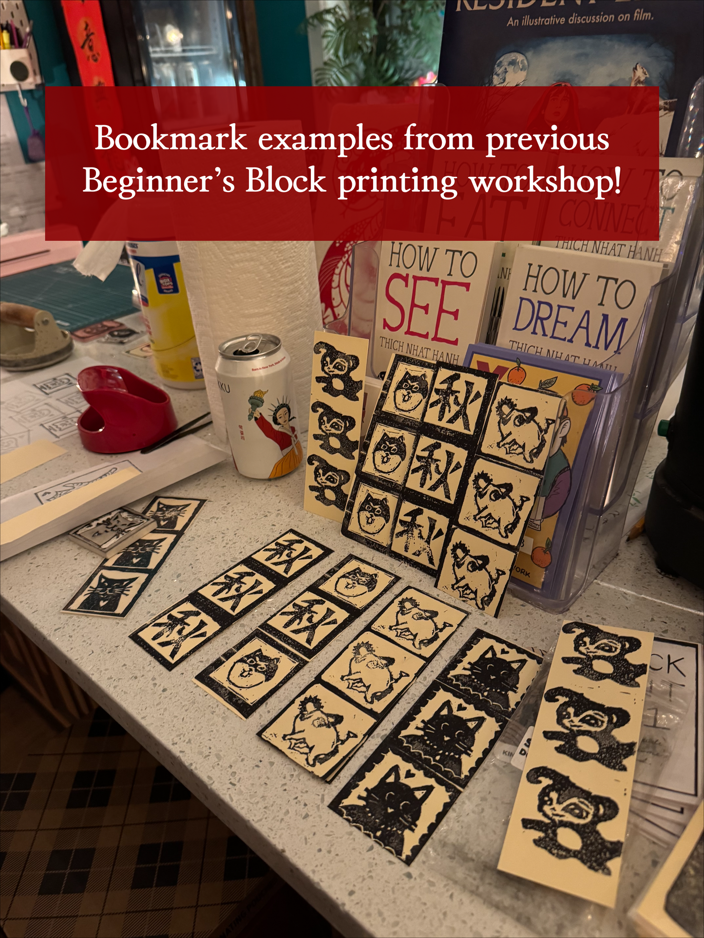 A display of black-and-white handmade bookmarks with unique designs at Yu & Me Books, created during the Lunar New Year Beginner's Block Printing Workshop with Kintsugi Print Studio. A red banner highlights past workshop bookmark examples.