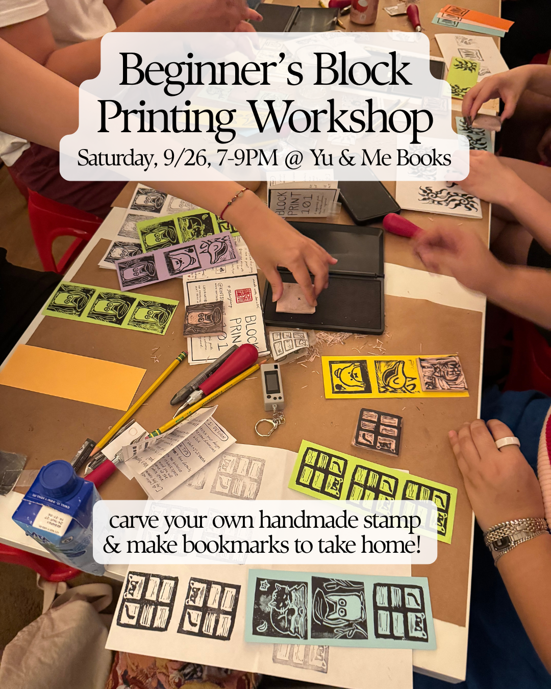 Participants gather around a table at Yu & Me Books, carving stamps and designing vibrant handmade bookmarks during the Beginner’s Block Printing Workshop with Kintsugi Print Studio. Flyers for the workshop are displayed on the table.