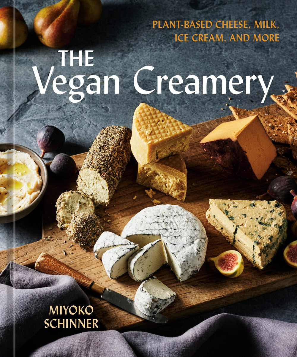Vegan Creamery by Miyoko Schinner (Signed & Personalized), offered by Yu & Me Books, showcases assorted plant-based cheeses and figs, promoting vegan recipes for cheese, milk, ice cream, and more.