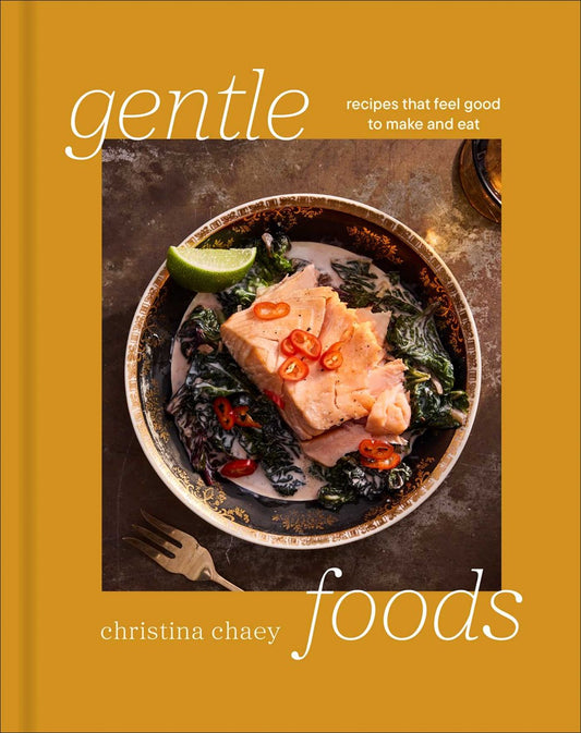 Cookbook cover for Gentle Foods by Christina Chaey (Signed & Personalized) featuring a bowl of salmon and leafy greens in a creamy sauce, garnished with chili slices and lime, with the title and author printed on a mustard-yellow border.