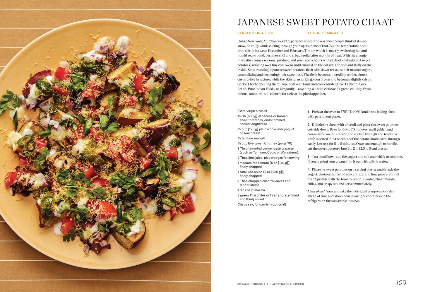 A plate of Japanese sweet potato chaat sits beside a recipe page from "East to East by Rachel Gurjar (Signed & Personalized)" by Yu & Me Books, topped with yogurt, pomegranate, tomatoes, herbs, sev, and chutneys on a striped brown surface.