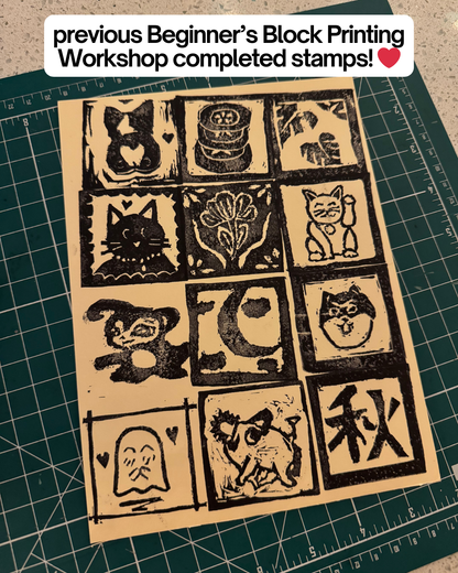 A sheet of cat, flower, and symbol stamps from the Beginner's Block Printing Workshop with Kintsugi Print Studio by Yu & Me Books is displayed on a green cutting mat. Text above reads: previous workshop completed stamps! ❤️.